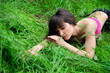 Photo: Girl portrait, lying in grass field. Girl portrait, lying in grass field.