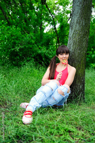 Photo: Woman with candy outdoor. Woman with candy outdoor.
