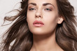 Sensual woman model with windswept flying brunette hair