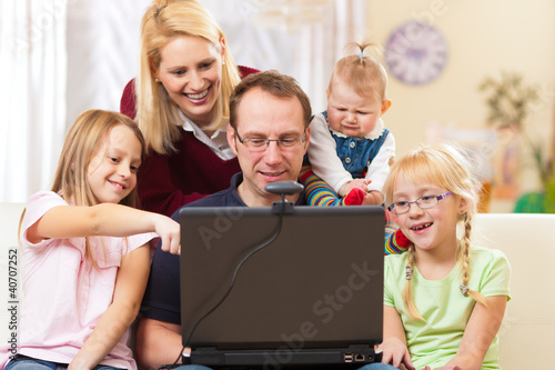 Photo: Family with computer having video conference Family with computer having video conference