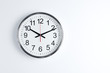 Silver shiny clock hanging at the wall with copy space