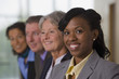 Hispanic businesswoman smiling with her colleagues
