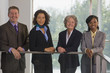 Business executives leaning against a railing