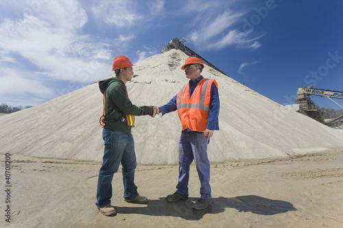 Photo: Two engineers shaking hands at a gravel and asphalt plant Two engineers shaking hands at a gravel and asphalt plant