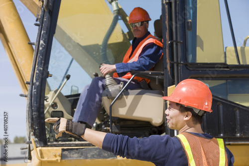Photo: Two engineers operating an earth mover Two engineers operating an earth mover