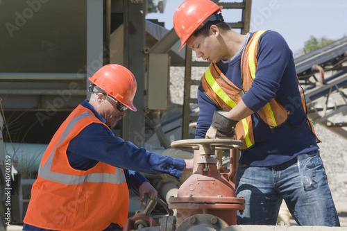 Photo: Two engineers working at a gravel and asphalt plant Two engineers working at a gravel and asphalt plant