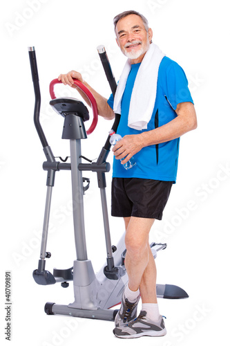 Photo: senior man exercising on stepper senior man exercising on stepper