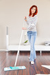 Foto: Junge rothaarige Frau bei der Hausarbeit Junge rothaarige Frau bei der Hausarbeit