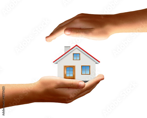 Photo: The house in hands isolated on white background The house in hands isolated on white background