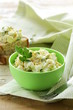 egg salad in a green cup with black bread