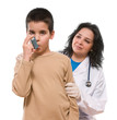 Doctor applying oxygen treatment on a little boy with asthma.