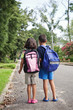 Grade School Boy and Girl Walking to School Bus Stop