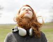 Young fashion girl with headphones at spring outdoor.
