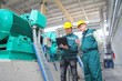 Foto: Industrial workers with notebook, teamwork Industrial workers with notebook, teamwork