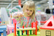 Photo: Adorable baby play with toys on table in mall Adorable baby play with toys on table in mall