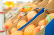 Orange pomelos in boxes in supermarket
