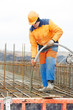 builder worker pouring concrete into form