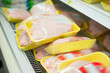 Variety of fresh chicken on shelves in supermarket
