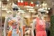 Two woman mannequins in dresses in supermarket