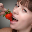beauty girl eating strawberries