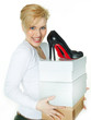 Pretty woman is carrying a lot of shoes