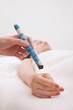 Hand applying moxa stick white background