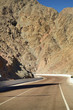 Empty road crossing an arid mountain