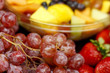 Grapes and Strawberries with Fruit in Background Grapes and Strawberries with Fruit in Background