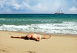 Young caucasian man sunbathing at a beach