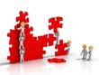 Travail d'équipe pour la construction d'un puzzle