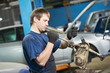 Foto: auto mechanic at work with wrench spanner auto mechanic at work with wrench spanner
