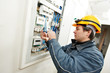 Electrician installing energy saving meter Electrician installing energy saving meter