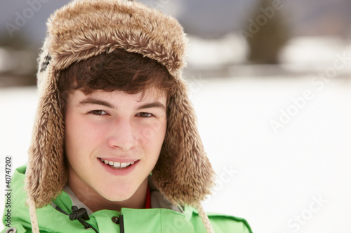 Photo: Portrait Of Teenage Boy In Snow Wearing Fur Hat Portrait Of Teenage Boy In Snow Wearing Fur Hat