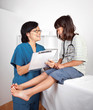 Female Doctor Talking with Little Girl Patient