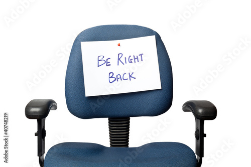 Photo: Office chair with a BE RIGHT BACK sign isolated on white Office chair with a BE RIGHT BACK sign isolated on white