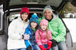 Photo: Family Sitting In Boot Of Car Wearing Winter Clothes Family Sitting In Boot Of Car Wearing Winter Clothes