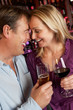 Couple Enjoying Drink Together In Bar