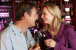 Couple Enjoying Drink Together In Bar