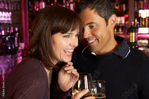 Photo: Couple Enjoying Drink Together In Bar Couple Enjoying Drink Together In Bar