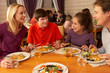 Foto: Family Eating Lunch Together In Restaurant Family Eating Lunch Together In Restaurant