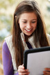 Photo: Teenage Girl Using Tablet Computer Outdoors Wearing Winter Cloth Teenage Girl Using Tablet Computer Outdoors Wearing Winter Cloth