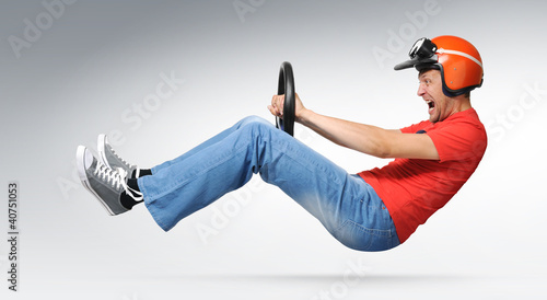 Photo: Mad man auto driver with steering wheel and helmet Mad man auto driver with steering wheel and helmet