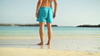 Legs of man standing on the beach