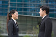 Photo: Two Asian business colleagues talking. Two Asian business colleagues talking.