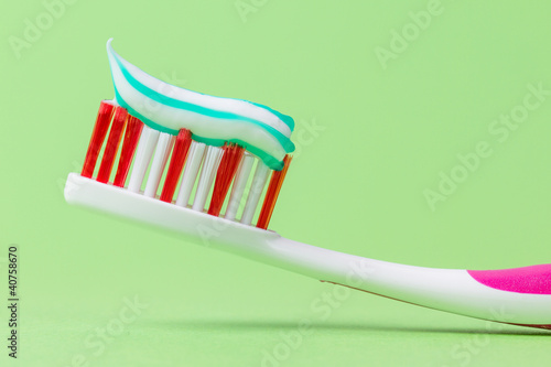Photo: A pink toothbrush with toothpaste A pink toothbrush with toothpaste