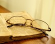 Glasses on vintage book.