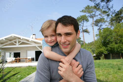 Photo: Father and daughter stood in front of their house Father and daughter stood in front of their house