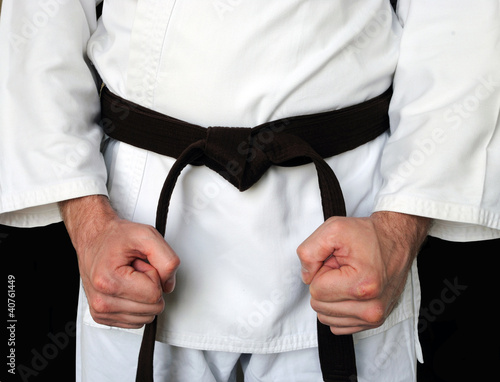 Photo: Man in a kimono and belt for martial arts Man in a kimono and belt for martial arts