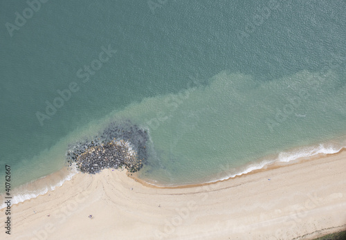 Photo: Aerial view of rocky deposits on beach Aerial view of rocky deposits on beach