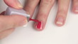Female painting her finger nails with nail polish. Female painting her finger nails with nail polish.